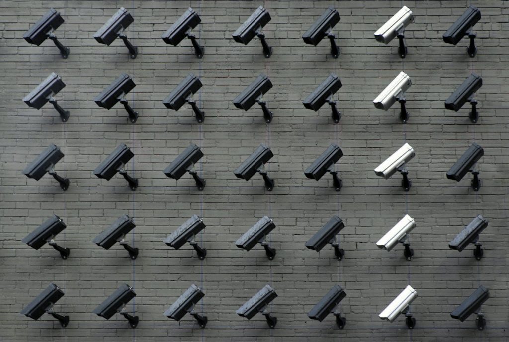 White CCTV security camera mounted on a wall